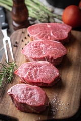 raw beef tenderloin on wooden cutting board