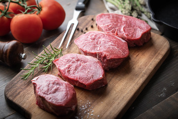 raw beef tenderloin on wooden cutting board