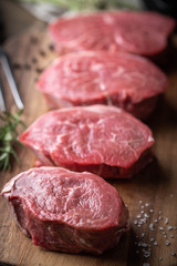 raw beef tenderloin on wooden cutting board
