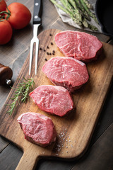 raw beef tenderloin on wooden cutting board