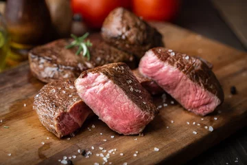 Foto op Canvas rare grilled tenderloin beef steak on cutting board with vegetables © ahirao