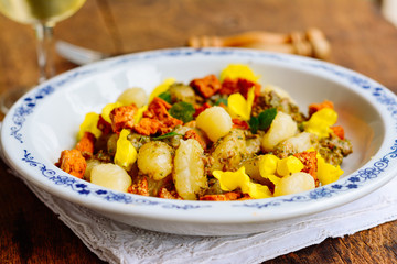 Gnocchi with Chickweed (Stellaria media) Pesto and Spicy Tofu Pieces. Garnished with mullein flowers.