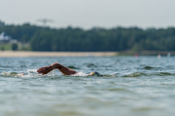 Triathlete swimming in a lake