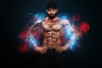 Fototapeta na wymiar Strong and fit man bodybuilder. Sporty muscular guy. Spot and fitness motivation. Man on fire like a phoenix.