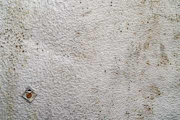 Gray metallic texture with steel nail in the corner. Rough surface with spots