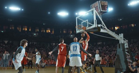 Basketball players on big professional arena during the game. Tense moment of the game. Celebration