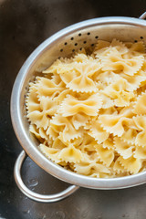 Cooked farfalle (bow-tie) pasta in a colander