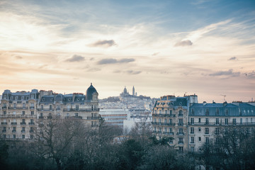 Montmartre Hill and Sacre Coeur basilica seen from Buttes Chaumont Park in Paris, France