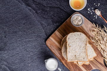 Fresh croissants and Bread slice on black slate background. Top view Copy space