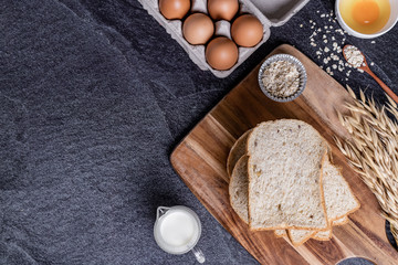 Fresh croissants and Bread slice on black slate background. Top view Copy space
