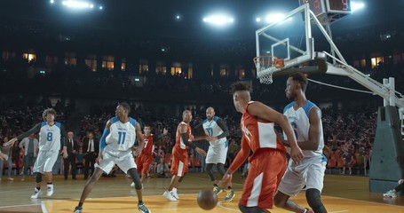 Basketball players on big professional arena during the game. Tense moment of the game. Celebration