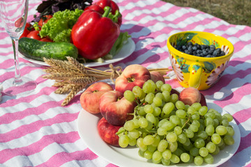 Grape and peach on a plate. Fruits close up. Beautiful picnic.