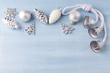 Christmas ornaments on bright wooden background. Top view. Copy space. 