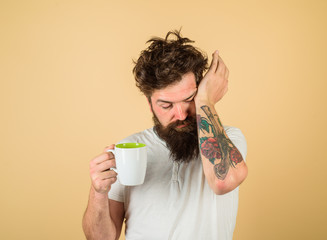 Bearded man with white coffee cup. Tired sleepy man with beverage in cup. Morning refreshment and...