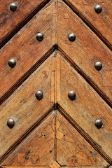 Fragment of old wooden doors with metal rivets
