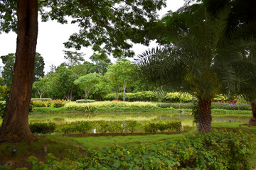 Kanchanaburi, Thailand, 09.09.2019: Beautiful garden, lake, traditional Thai, Siamese clothes, buildings of "Mallika City R.E. 124" a heritage, retro-city reflecting the real past Siamese lifestyle