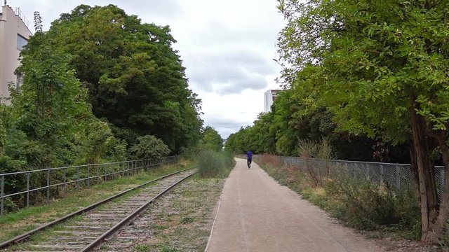 Paris, France: Man running on the old railways ring of the Petite Ceinture, transformed as a promenade area