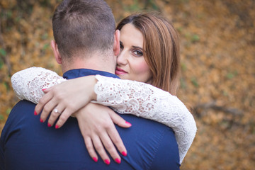Fiancee hugging her fiance. Autumn surrounding. Romantic love