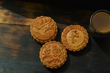 chinese moon cake on a wooden table and a black background