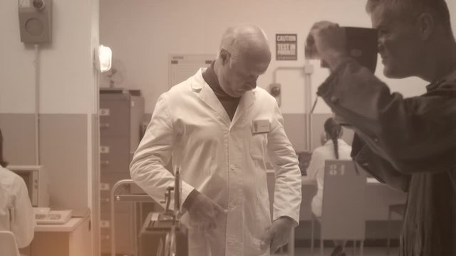Operator shooting a footage of a scientist expaining his project