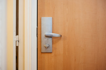 Aluminum steel door handle in modern hotel in Paris