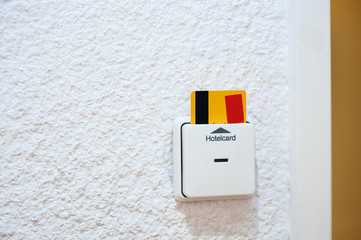 Yellow security hotelcard in the reader in the modern hotel room