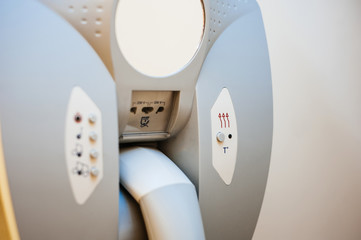 Close-up detail of hairdryer hanged on the wall of bathroom in modern hotel with power plug for the razor machine