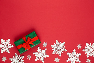 Christmas holiday present box on red background.
