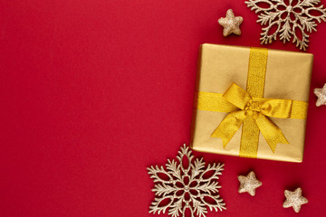 Christmas, holiday present box on red background.