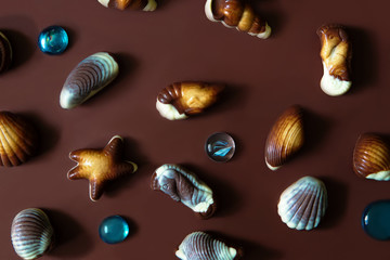 Assorted Chocolate pralines on brown background.
