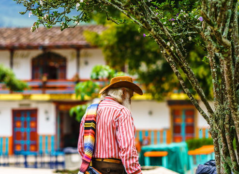 Man wearing a sombrero and folded poncho over the shoulder in colonial village of Jardin, Colombia