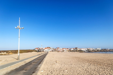 View to Surfer beach Praia do Lagido and island Baleal with fishing village in summer, Peniche...