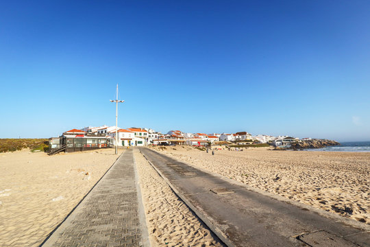View to Surfer beach Praia do Lagido and island Baleal with fishing village in summer, Peniche Portugal