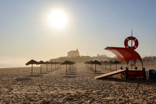 View to Surfer beach Praia do Lagido and island Baleal with fishing village in summer, Peniche Portugal