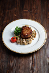 Meat medallion with mushrooms. restaurant menu