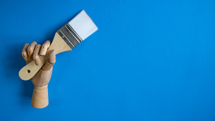Artist's poseable hand with paintbrush. Art concept