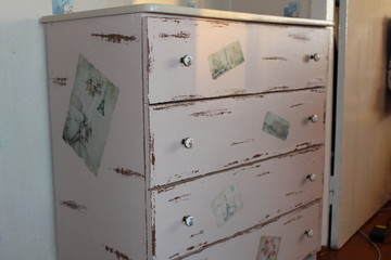 Chest of drawers with his hands.