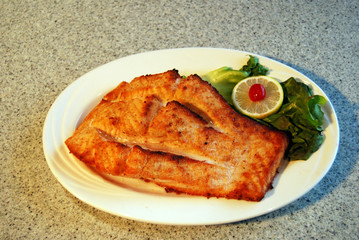 Plate of broiled salmon from diner, cooked to perfection