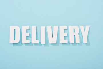 white delivery text with shadow on blue background with copy space