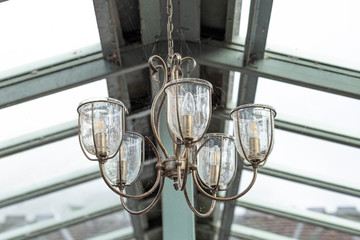 Fototapeta na wymiar Decorative Brass Suspended Light Covered in Cobweb