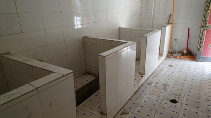 CLOSE UP: Empty public toilets in remote Tibetan town with waist high dividers.