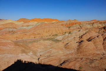 AERIAL: Scenic view of the famous Rainbow mountains from a tourist viewpoint