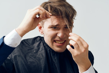 The man at the hairdresser has a bad hairstyle