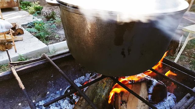 Bograch. Soup with paprika, meat, bean, vegetable, dumpling. Traditional Hungarian Goulash in cauldron. Meal cooked outdoors on an open fire. Delicious and healthy food popular in Central Europe