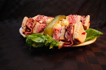 Corned Beef Club Sandwich with Swiss Cheese on a black background