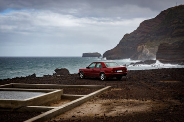 The car near the ocean, rocky coast.