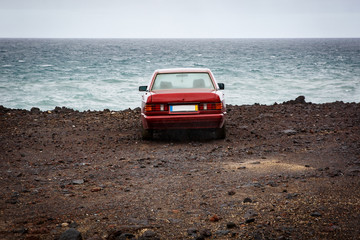 The car near the ocean, rocky coast.