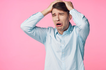 portrait of young man with hands on his head