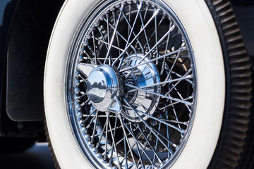 Closeup of vintage car wire wheel tyre. Retro car tire