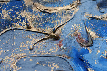 The paint flows. Mixing gold and blue. Relief technique in painting